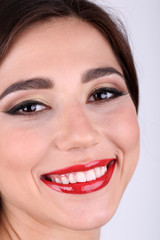 Smiling woman with red lips close-up