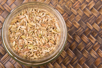 Cumin seeds over a wicker background 