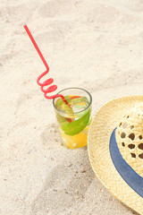 Cold drink with ice, mint and lemon on the beach