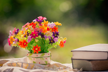 bouquet of flowers and book in nature background