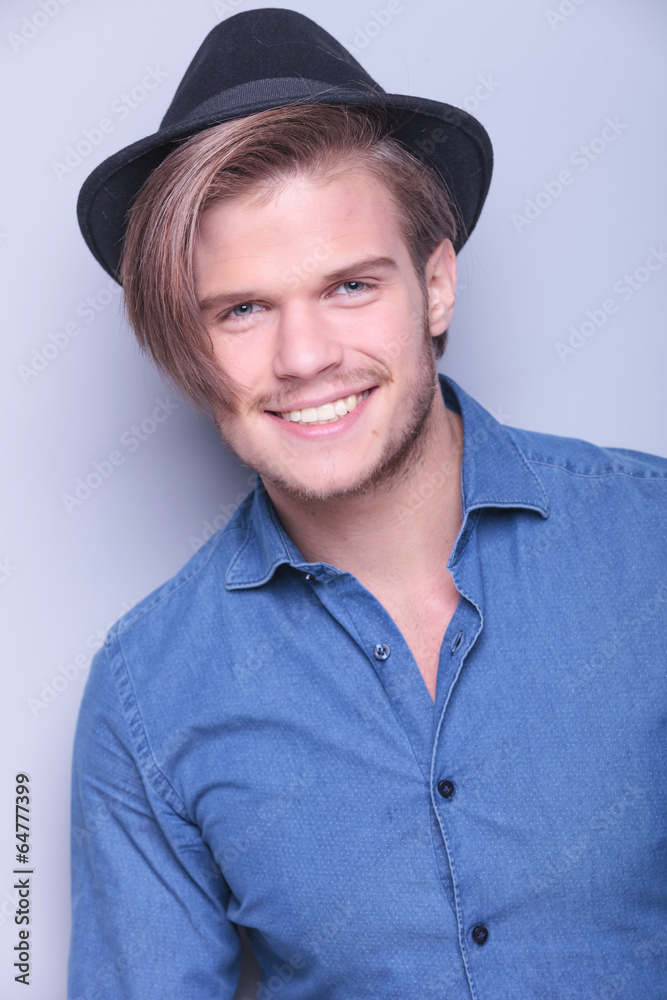 Poster happy young man wearing hat smiles