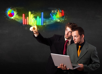 Young business people touching colorful modern graph system conc