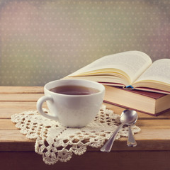Cup of tea on crochet doily and vintage books