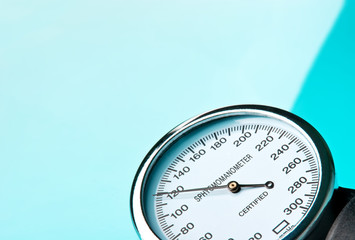 Sphygmomanometer on blue, reflective background