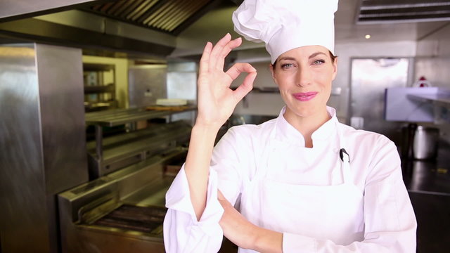 Pretty chef making ok sign to camera