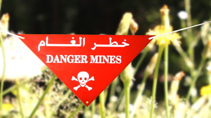 Warning sign in front of a minefield