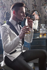 Gentleman with cigar and whisky in the nightclub