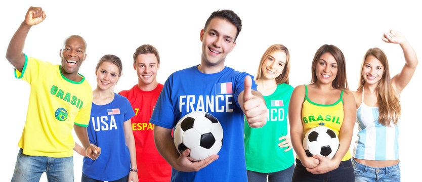 French soccer fan with football showing thumb up with other fans