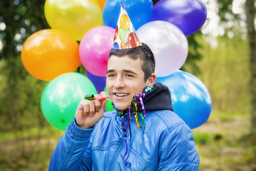 Teen with balloons in birthday party at outdoors
