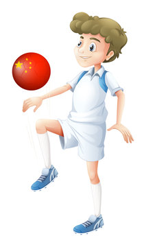 A boy using the soccer ball with the flag of China