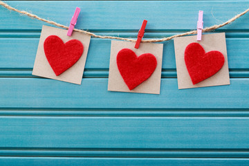 Hand-crafted felt hearts hanging with clothespins