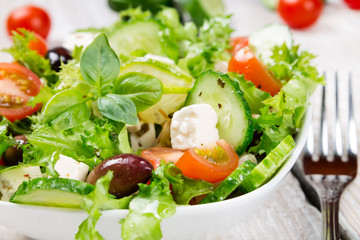 Salad with fresh vegetables in a ceramic bowl