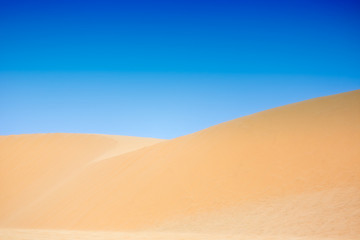 Fototapeta na wymiar White sand dunes with blue skies, Mui Ne, Vietnam