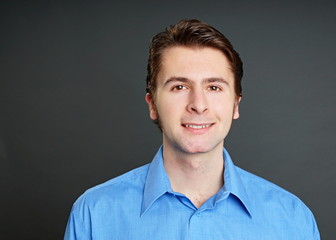 Obraz premium Young man at blue shirt, left you can write some text