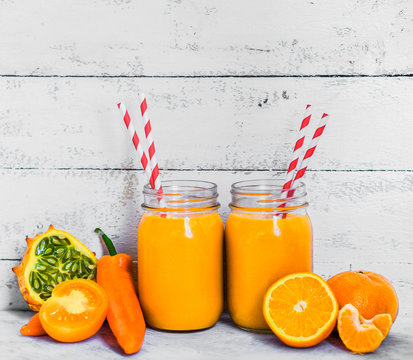 Orange smoothie on rustic background