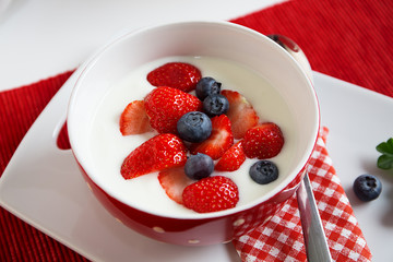 Fresh strawberries with yoghurt for breakfast
