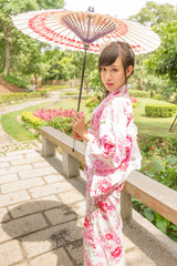 Asian woman in a yukata, holding an umbrella in Japanese style g