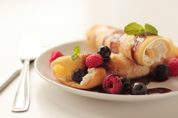 Pancakes with fruits blueberry raspberry and chocolate syrup