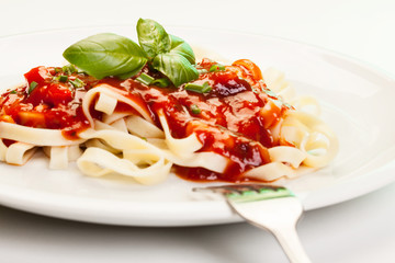 Pasta fettuccine with tomato sauce and basil