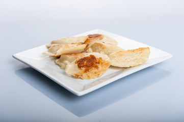 fried dumplings on white plate