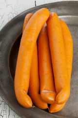 Vienna sausages on old plate