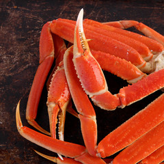 Crab legs on brown background - 64802559