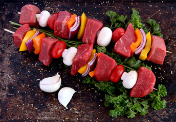 Uncooked beef kebabs with vegetables and spices - 64802564