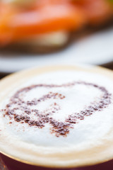 A cup with foam and a chocolate heart