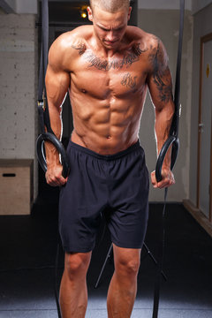 A professional shot of a tatooed athlete excercising
