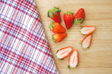 Fresh strawberries on wooden plate
