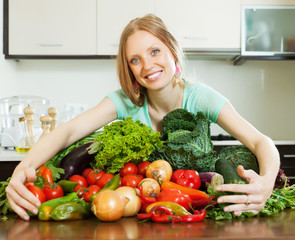 happy woman with heap of vegetables