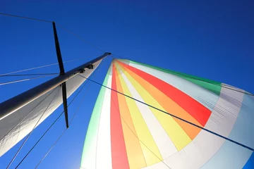 Photo sur Plexiglas Naviguer The wind has filled colorful spinnaker sail