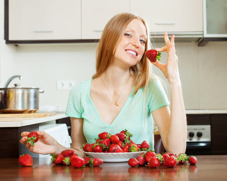 long-haired girl eating strawberry