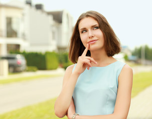 Young woman standing near house, isolated on white background