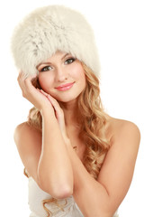 Beauty fashion model girl in a fur hat.