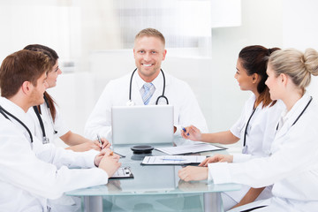 Confident Doctors At Desk