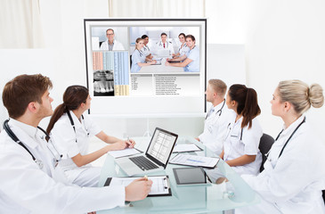 Team Of Doctors Looking At Projector Screen