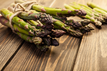 Bunch of young asparagus on wooden table