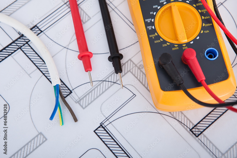 Poster multimeter with wires on blueprint
