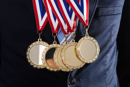 Businessman Wearing Gold Medals