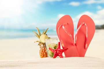 Summer beach with red sandals and shells