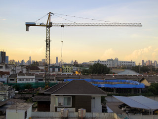 Fototapeta na wymiar Industrial landscape with cranes on the blue sky