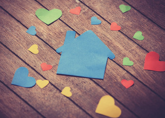Paper house on wooden table.