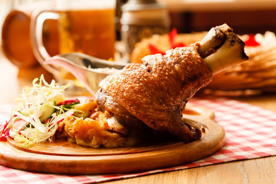 eisbein with braised cabbage, salad and beer