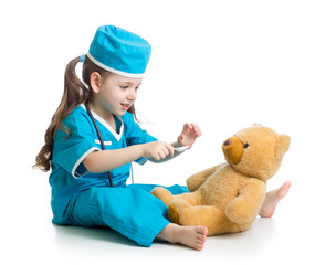 kid girl playing doctor with toy