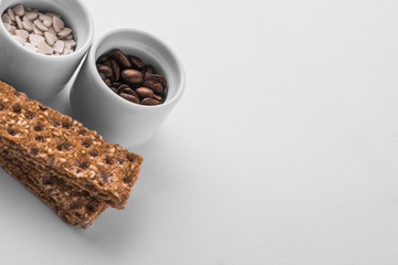 Set of saucers full of coffee beans and candy with crispbread