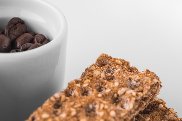 Set of saucers full of coffee beans with crispbread