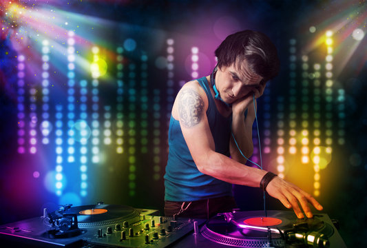 Dj playing songs in a disco with light show