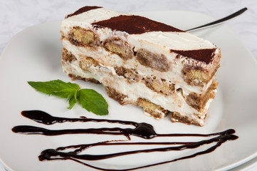 Slice of self-made italian tiramisu dessert served on a plate