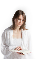 Young woman reading a Bible and thinking
